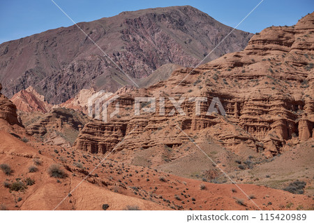 Kyrgyzstan nature, Konorchek Canyon valley. Red sandstone rocks, cliffs. Famous travel place, natural background  115420989