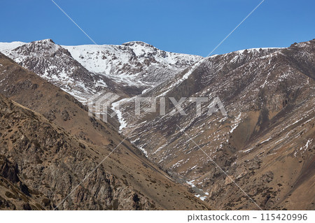 First snow in mountains. Autumn nature, brown mountain slope First snow in mountains. Autumn nature, brown mountain slope 115420996