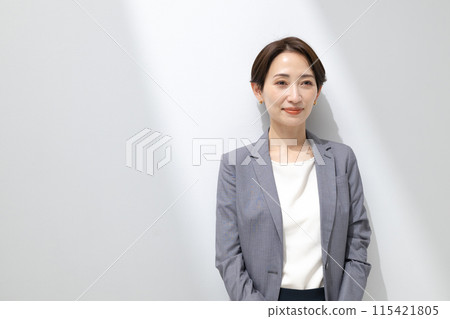 A woman standing with a smile A woman standing with a smile 115421805