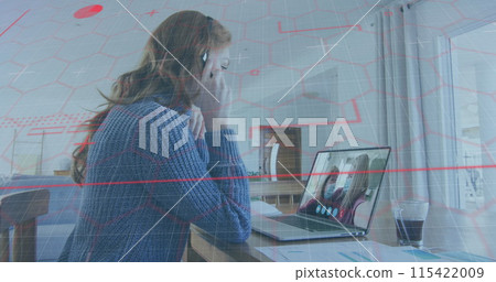 Caucasian woman on a video call, focused on her laptop screen Caucasian woman on a video call, focused on her laptop screen 115422009