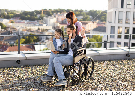 Happy family spending time together on rooftop with laptop 115422846