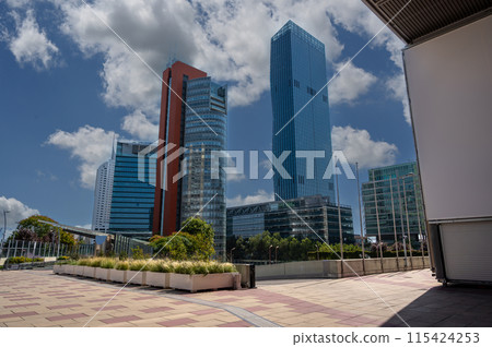 Vienna, Austria, August 17, 2022. Donau City, or Vienna DC is the city district characterized by modern skyscrapers. On the right the characteristic DC Tower 1. Beautiful sunny day. 115424253