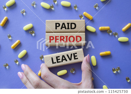 Paid Period Leave symbol. Concept words Paid Period Leave on wooden blocks. Beautiful purple background with pills. Doctor hand. Healthcare and Paid Period Leave concept. Copy space. Paid Period Leave symbol. Concept words Paid Period Leave on wooden blocks. Beautiful purple background with pills. Doctor hand. Healthcare and Paid Period Leave concept. Copy space. 115425730