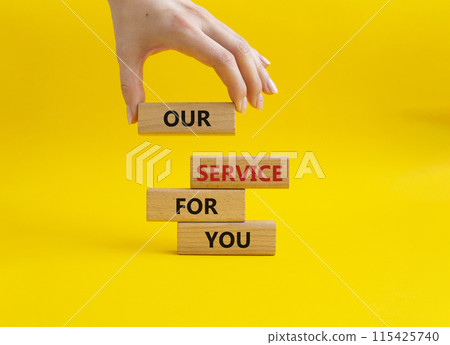 Our service for you symbol. Wooden blocks with words Our service for you. Beautiful yellow background. Businessman hand. Business and Our service for you concept. Copy space. 115425740