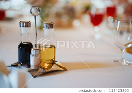 Set of containers for spices, oil and vinegar on a metal stand Set of containers for spices, oil and vinegar on a metal stand 115425893