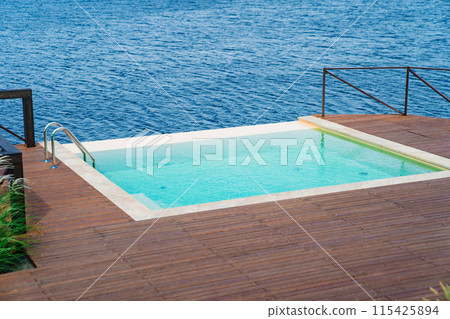 Terrace with swimming pool by the river. Terrace with swimming pool by the river. 115425894