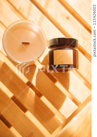 Scented candles on a wooden table. Scented candles on a wooden table. 115426003