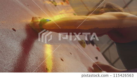 Image of sunset over caucasian woman climbing wall 115426563