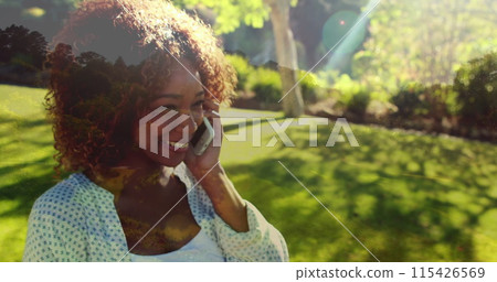 Close up of an African-american woman calling on her phone while giggling 115426569