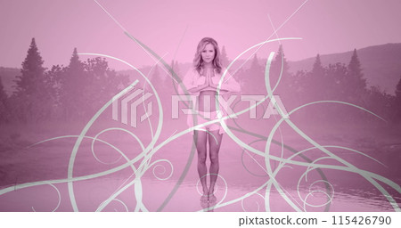 Front view of a Caucasian woman doing yoga on a background of trees Front view of a Caucasian woman doing yoga on a background of trees 115426790