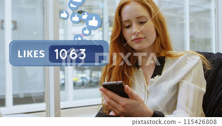 Close up of a red haired Caucasian woman texting in the office 115426808