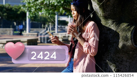 Side view of a female Caucasian teenager wearing a cap leaning against a tree in the park Side view of a female Caucasian teenager wearing a cap leaning against a tree in the park 115426854