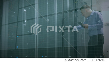 Caucasian man reviews data in a server room at the office Caucasian man reviews data in a server room at the office 115426969
