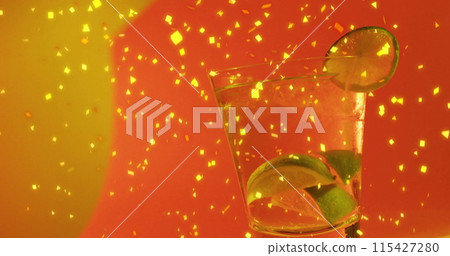 Image of confetti falling and cocktail on red background Image of confetti falling and cocktail on red background 115427280