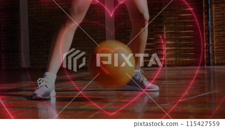 Image of neon hearts over caucasian female basketball player bouncing ball 115427559