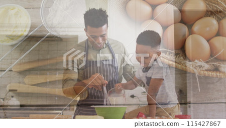 Image of happy african american father and son baking over eggs and basket 115427867