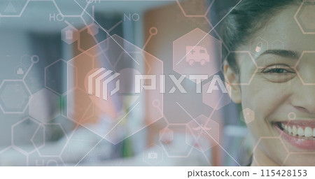 Image of heart beat, medical icons and cells over half face of smiling biracial female doctor Image of heart beat, medical icons and cells over half face of smiling biracial female doctor 115428153