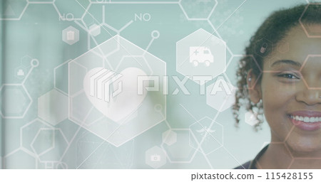 Image of heart beat, medical icons and cells over smiling african american female doctor Image of heart beat, medical icons and cells over smiling african american female doctor 115428155