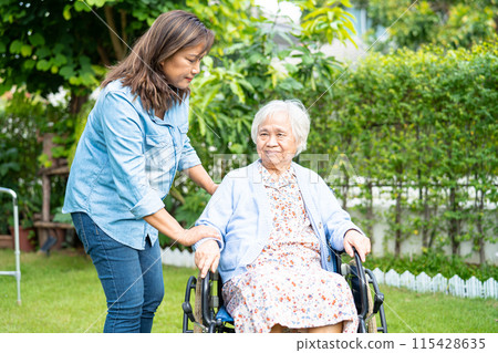 Caregiver help and care Asian senior woman patient sitting on wheelchair at nursing hospital ward, healthy strong medical. 115428635