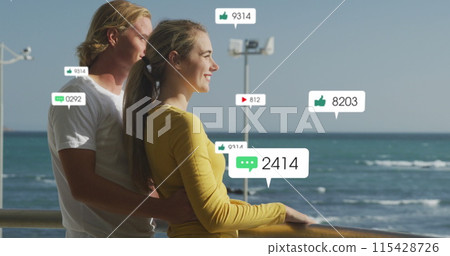 Image of social media icons over happy couple by seaside Image of social media icons over happy couple by seaside 115428726