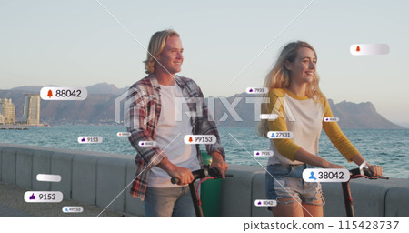 Image of social media notifications over smiling couple using scooters on holiday by the sea Image of social media notifications over smiling couple using scooters on holiday by the sea 115428737