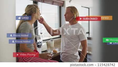 Image of social media notifications over happy couple having breakfast in sunny kitchen Image of social media notifications over happy couple having breakfast in sunny kitchen 115428742