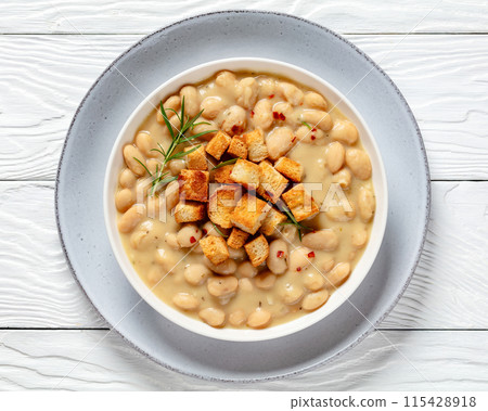 rosemary garlic creamy white bean soup in bowl 115428918