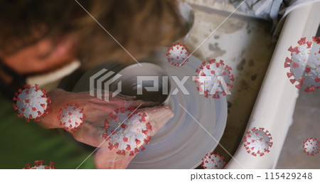 Composite image of covid-19 cells floating against close up of hands working on pottery wheel Composite image of covid-19 cells floating against close up of hands working on pottery wheel 115429248
