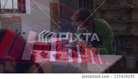 Image of covid 19 cells and statistics over man working in pottery studio wearing face mask 115429295