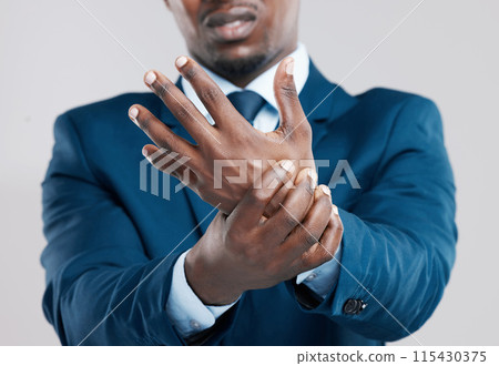 Hands, pain and African businessman with injury in studio from tension, arthritis and stress. Wrist, muscle and problem or sprain by white background with unhappy, corporate and male person in suit Hands, pain and African businessman with injury in studio from tension, arthritis and stress. Wrist, muscle and problem or sprain by white background with unhappy, corporate and male person in suit 115430375