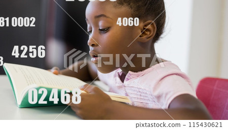 African American girl focused on reading a book at school African American girl focused on reading a book at school 115430621