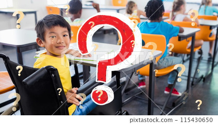 Image of question marks over smiling asian schoolboy in wheelchair in classroom 115430650