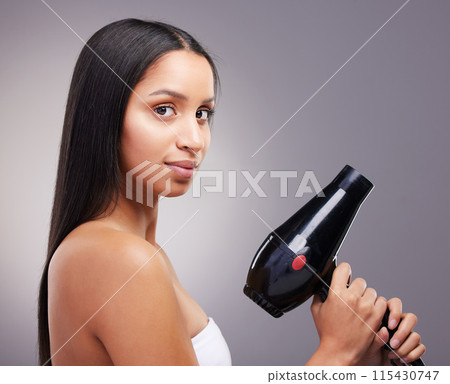 Cosmetics, woman and portrait with hairdryer in studio grey background for wellness and self care. Female person, heat treatment and equipment isolated on backdrop for salon shine, style and keratin Cosmetics, woman and portrait with hairdryer in studio grey background for wellness and self care. Female person, heat treatment and equipment isolated on backdrop for salon shine, style and keratin 115430747