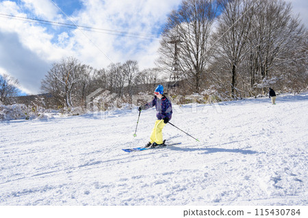 Female students enjoying skiing 115430784
