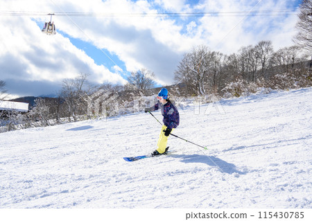 Female students enjoying skiing 115430785