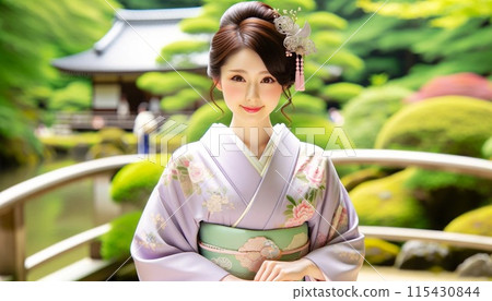 Young woman in kimono standing in front of a Japanese garden 115430844