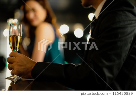 Men and women drinking at a bar 115430889