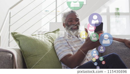 Image of falling icons over african american senior man using smartphone 115430896