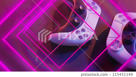 Image of neon light trails over image game computer pads 115431149