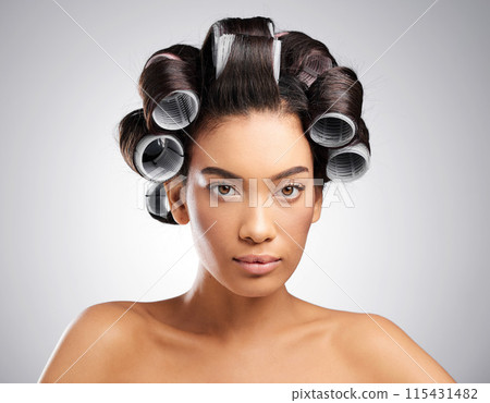 Portrait, woman and rollers in studio for hair care, hairstyle and treatment on gray background. Styling equipment, cosmetics and female person in salon for beauty, skincare and tools for curls Portrait, woman and rollers in studio for hair care, hairstyle and treatment on gray background. Styling equipment, cosmetics and female person in salon for beauty, skincare and tools for curls 115431482
