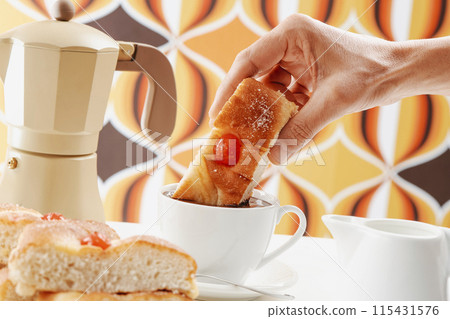 dipping catalan coca de sant joan in hot chocolate 115431576