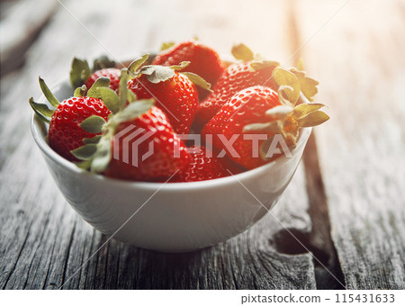 Strawberry, bowl and table with healthy food and fruit for wellness, nutrition and to lose weight. Home, breakfast and sustainable meal or health snack with vitamin A and diet dessert for eating Strawberry, bowl and table with healthy food and fruit for wellness, nutrition and to lose weight. Home, breakfast and sustainable meal or health snack with vitamin A and diet dessert for eating 115431633