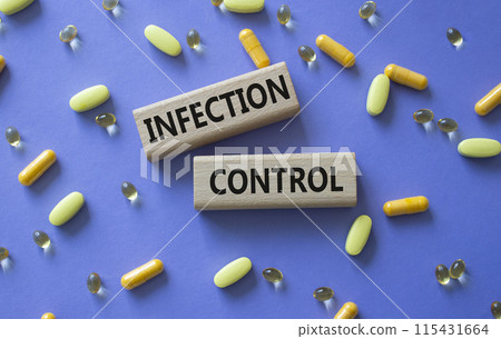 Infection Control symbol. Concept word. Infection Control on wooden blocks. Beautiful purple background with pills. Medicine and Infection Control concept. Copy space 115431664
