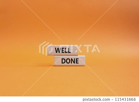 Well done symbol. Wooden blocks with words Well done. Beautiful orange background. Business and Well done concept. Copy space. 115431668