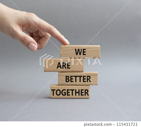 We are better together symbol. Wooden blocks with words We are better together. Beautiful grey background. Businessman hand. We are better together concept. Copy space. We are better together symbol. Wooden blocks with words We are better together. Beautiful grey background. Businessman hand. We are better together concept. Copy space. 115431721
