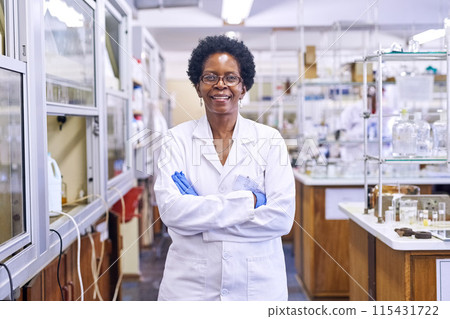 Scientist, lab and portrait of black woman with arms crossed for healthcare, medical research and pride. Science, happy and face with smile for medical test, vaccine study and pharmaceutical service Scientist, lab and portrait of black woman with arms crossed for healthcare, medical research and pride. Science, happy and face with smile for medical test, vaccine study and pharmaceutical service 115431722