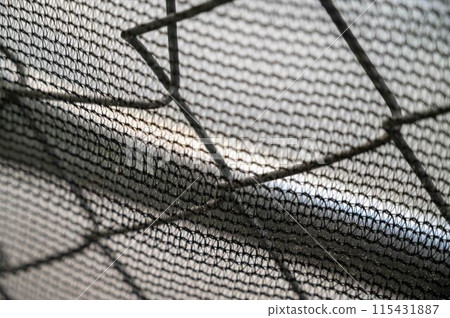 Closeup chain link fence with mesh barrier Closeup chain link fence with mesh barrier 115431887