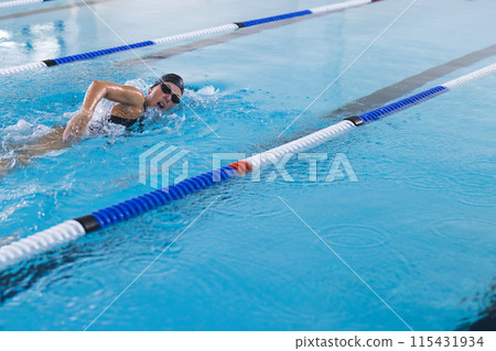 Caucasian female athlete swimmer swimming in a pool 115431934