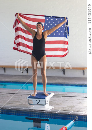 Caucasian female athlete swimmer celebrates victory at a swimming pool 115431949