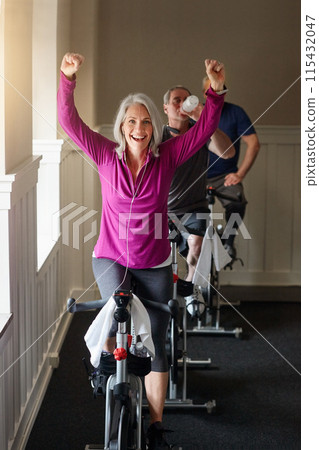 Gym, winning or happy woman on cycling bike in workout or cardio training for progress, portrait or wellness. Class, exercise or excited senior person on bicycle machine for fitness, success and goal 115432047